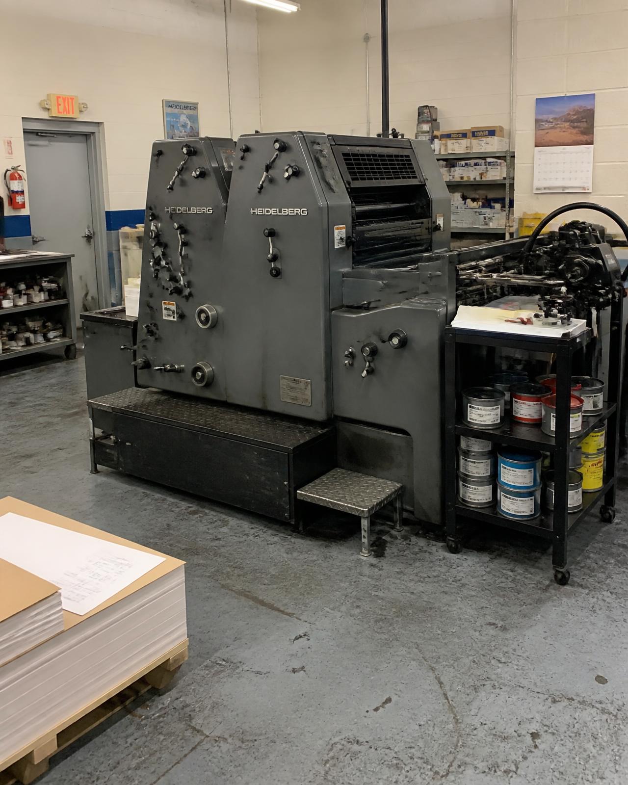 Two color offset press and ink cart on the shop floor at Derby Printing
